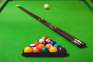 pool table with two cues and racked set
